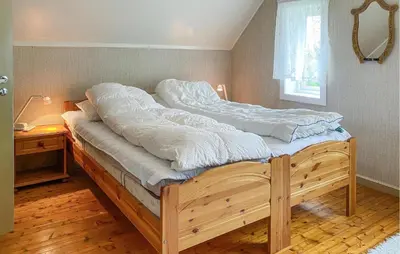 a large bed in a room with a window at Awesome Home In Åheim With Wifi in Åheim