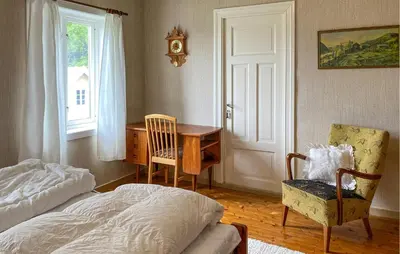 a bedroom with a bed and a desk and a chair at Awesome Home In Åheim With Wifi in Åheim
