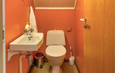 a small bathroom with a toilet and a sink at Awesome Home In Åheim With Wifi in Åheim