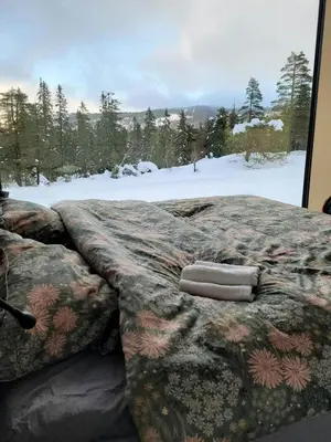 a bed in a room with a view of snow at Modern Cabin At Blefjell in Svene