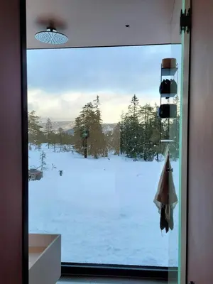 a view of a snow covered yard through a window at Modern Cabin At Blefjell in Svene