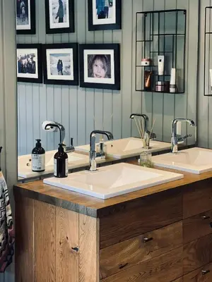 a bathroom with two sinks and two mirrors at Spacious Family Cabin In Western Golsfjellet in Gol