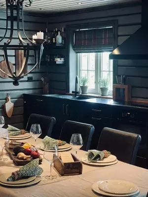 a table with plates of food and wine glasses at Spacious Family Cabin In Western Golsfjellet in Gol