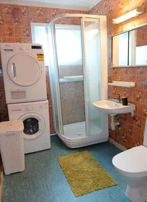 a bathroom with a shower and a washing machine at Stryn Norway in Stryn