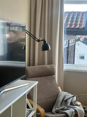 a room with a desk with a computer and a chair at Leilighet nær Color Line i Larvik in Lii