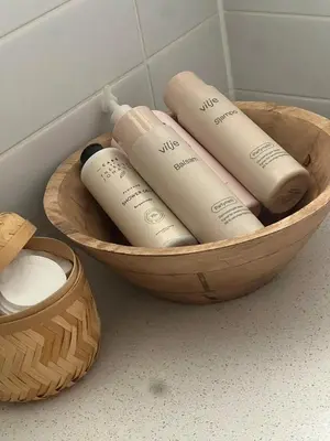 a wooden bowl with four bottles in it at Leilighet nær Color Line i Larvik in Lii