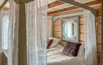 a bedroom with a canopy bed with a mirror at 4 Bedroom Gorgeous Home In Hovden I Setesdal in Hovden