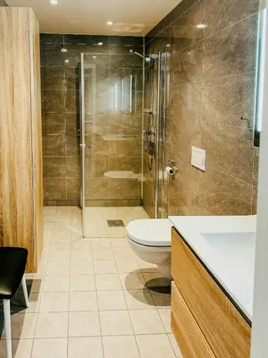 a bathroom with a shower and a toilet and a sink at Mountain Apartment With Views In Myrkdalen in Vossestrand