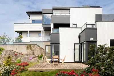 a house with a deck in front of it at Panoramic view with private terrace in Bergen