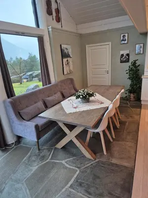 a living room with a table and a couch at Idyllic house with views - close to nature in Nydalen