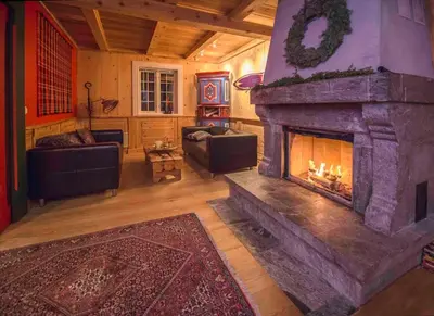 a living room with a large stone fireplace at Family Cabin For Many In The High Mountains in Hovet