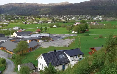an aerial view of a small town with houses and a field at Cozy Apartment In Fitjar in Fitjar