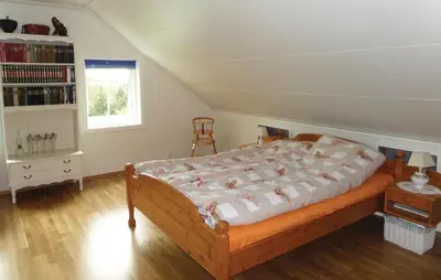 a bedroom with a large bed in a attic at Cozy Apartment In Fitjar in Fitjar