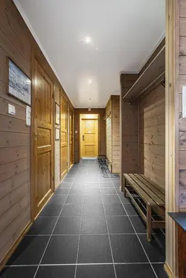 an empty hallway with wooden walls and a yellow door at Spacious Family Apartment in Hemsedal, Ski In-Out, Sauna, 30m from Skarsnuten hotell in Hemsedal