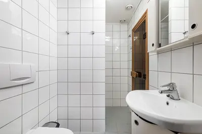 a white bathroom with a sink and a toilet at Spacious Family Apartment in Hemsedal, Ski In-Out, Sauna, 30m from Skarsnuten hotell in Hemsedal