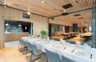 a large dining room with a long table and chairs at LADE - leilighet i Ringve Pluss in Trondheim