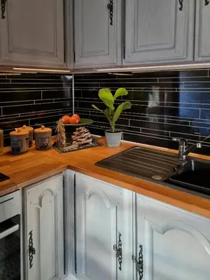 a kitchen with white cabinets and a sink at Traditional Family Cabin Near Rabalen in Bagn