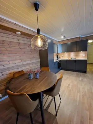 a dining room with a wooden table and chairs at Apartment in Voss - Tråstølen in Skulestadmo