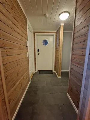 a hallway with wooden walls and a white door at Apartment in Voss - Tråstølen in Skulestadmo