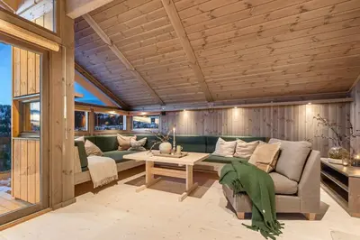 a living room with a couch and a table at Hedda Hedalsfjellet - 3 bedroom cabin with a lovely view in Hedalen