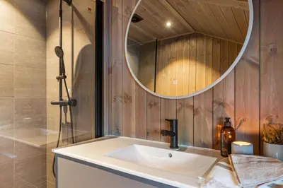 a bathroom with a sink and a mirror at Hedda Hedalsfjellet - 3 bedroom cabin with a lovely view in Hedalen