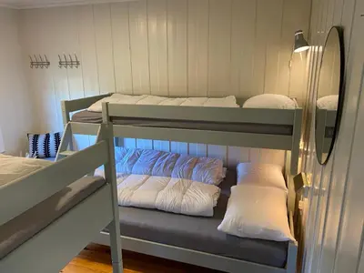 two bunk beds in a room with a mirror at Fjellheimens Svanebu in Tyinkrysset