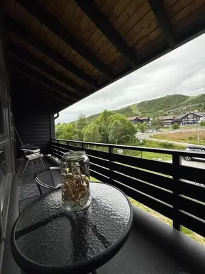 a glass jar sitting on top of a table on a balcony at Geiloholtet central city apartment in Geilo