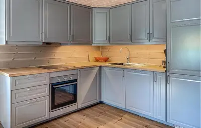 a kitchen with white cabinets and a sink at Cozy Home In Hornindal With Sauna in Hornindal