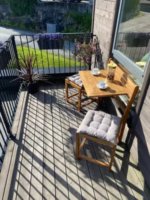 a patio with a table and chairs on a balcony at Familyhome for 8 people - 4 bedrooms - 10min from Bergen city center in Bergen