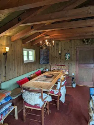a wooden dining room with a wooden table and chairs at Bloksberg - cabin with amazing view and ski inn-out in Geilo