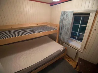 a small room with a bunk bed and a window at Hansali Holiday Home in Fjarland