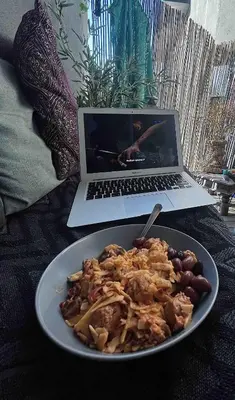 a plate of food on a table with a laptop at Beautiful apartment in the city center in Lii