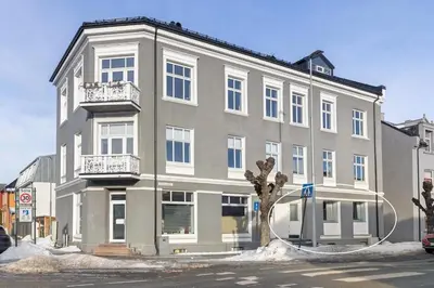 a large gray building with a tree in front of it at Beautiful apartment in the city center in Lii