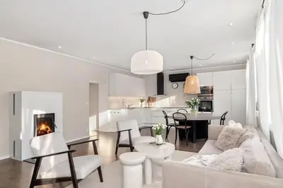 a white living room with a couch and a fireplace at Beautiful apartment in the city center in Lii