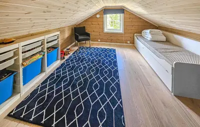 a small room with a bed and a rug at Awesome Home In Vinje With Sauna in Trovatn