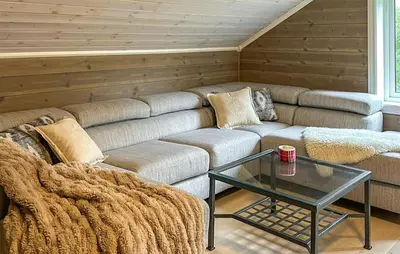 a living room with a couch and a glass table at 4 Bedroom Gorgeous Home In Edland in Vågsli