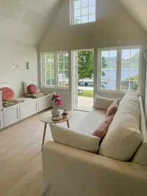 a living room with a couch and a table at Renovated 1918 House By The Sea In Sandeid in Sandeid