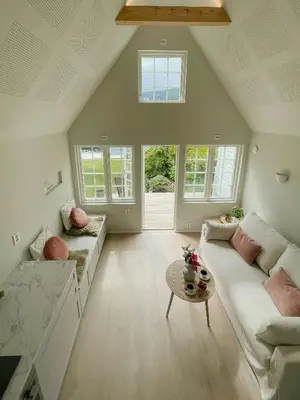 a living room with a couch and a table at Renovated 1918 House By The Sea In Sandeid in Sandeid