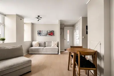 a living room with a table and a couch at City Apartment I Short Walk to Sights in Bergen