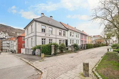 a row of white houses on a street at City Apartment I Short Walk to Sights in Bergen