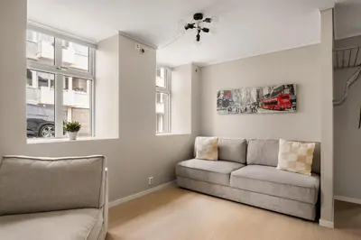 a living room with a couch and a window at City Apartment I Short Walk to Sights in Bergen