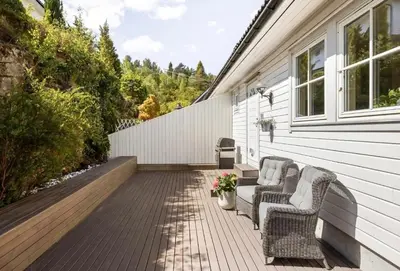 a patio with two chairs on a house at Sentrumsnær bolig in Lii