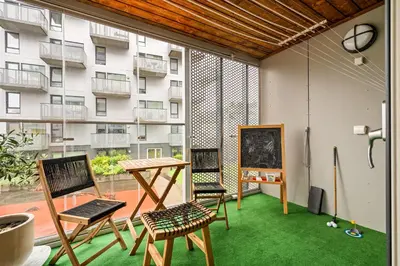 a room with chairs and a table and a building at Modern & Spacious City Apartment in Bergen