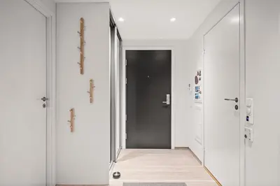 a hallway with two doors and a mirror at Modern & Spacious City Apartment in Bergen