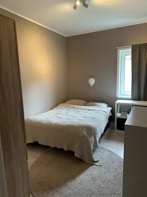 a bedroom with a bed and a window at Modern apartment in beautiful Lofoten in Lii