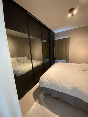 a bedroom with two beds and a large closet at Modern apartment in beautiful Lofoten in Lii