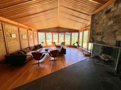 a living room with a couch and a fireplace at Historic Cabin By Lærdal River in Tønjum