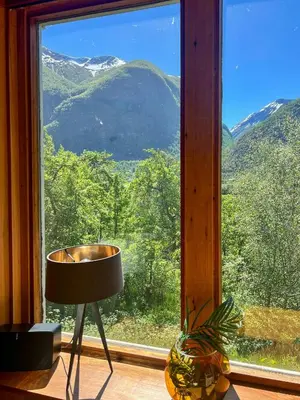 a window with a view of a mountain at Historic Cabin By Lærdal River in Tønjum