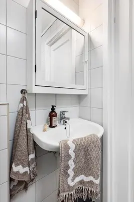a bathroom with a sink and a mirror and towels at Charming Apartment, Walk to Everything in Bergen in Lii