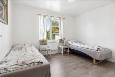 a bedroom with two beds and a window at Family & Friends Space in Råholt in Lii